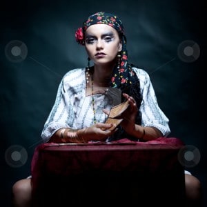 a portrait of a gypsy fortune teller mixing the tarot cards.